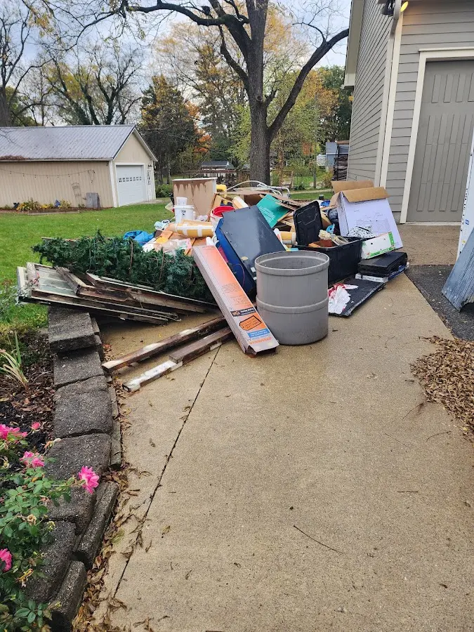 Dumpster being loaded with debris for 3 Yard Dumpster Rental in Alaiedon